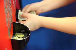 Child Putting Money in Arcade Token Change Machine free creative commons